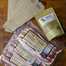 Load image into Gallery viewer, Bacon packages with labels on a wooden surface