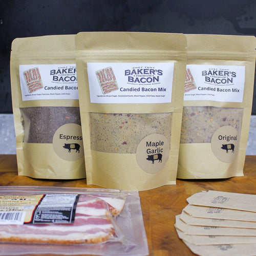 Three packages of Baker's Bacon Candied Bacon Mix on a wooden surface with additional packaging and bacon slices.